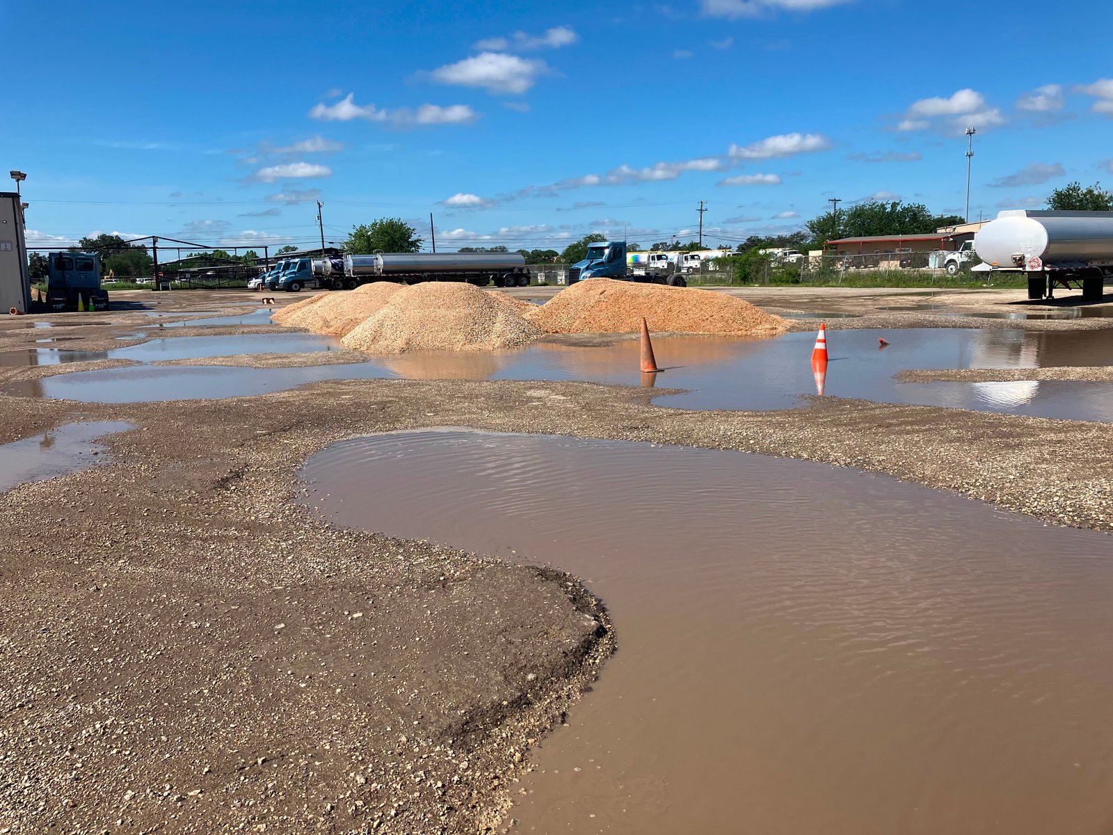 Aggregate base material staged for commercial parking lot construction