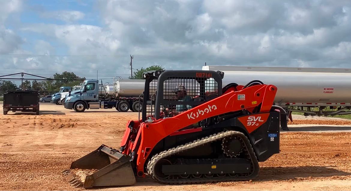 Track loader preparing a commercial parking lot